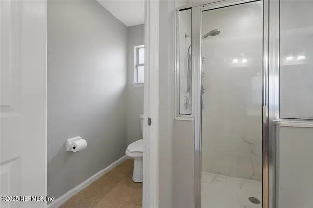 a bathroom that has a glass shower door