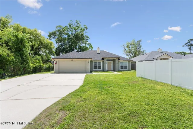 a front view of house with yard and green space