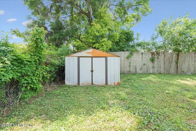 a garden with a small yard and large trees