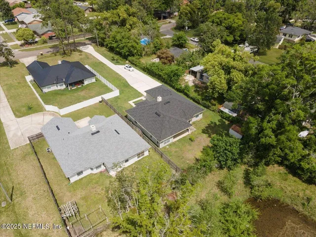 an aerial view of a house with a swimming pool