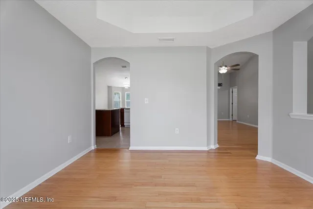 a view of a room with wooden floor and staircase