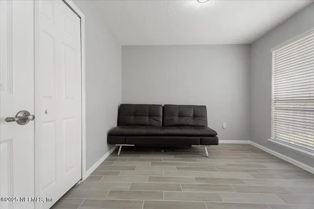 a living room with furniture and a window