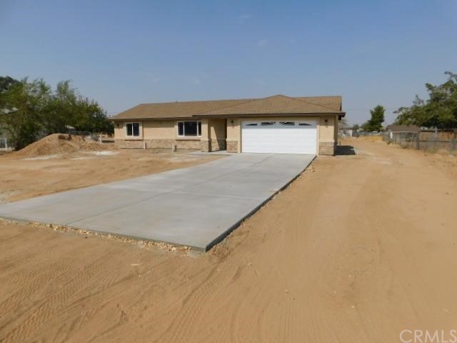 22380 Sioux Road Apple Valley, CA 92308 - Photo 1 of 1 a front view of a house with a yard
