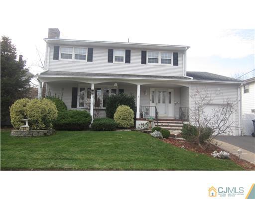 57 South Cliff Road Colonia, NJ 07067 - Photo 1 of 15 a black and white house with a big yard and potted plants