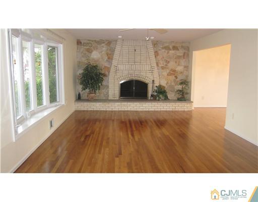 57 South Cliff Road Colonia, NJ 07067 - Photo 2 of 15 a open hall with wooden floor and a fireplace