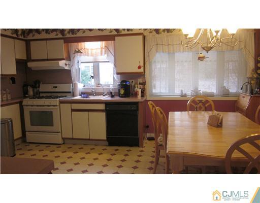57 South Cliff Road Colonia, NJ 07067 - Photo 5 of 15 a kitchen with a sink cabinets and window