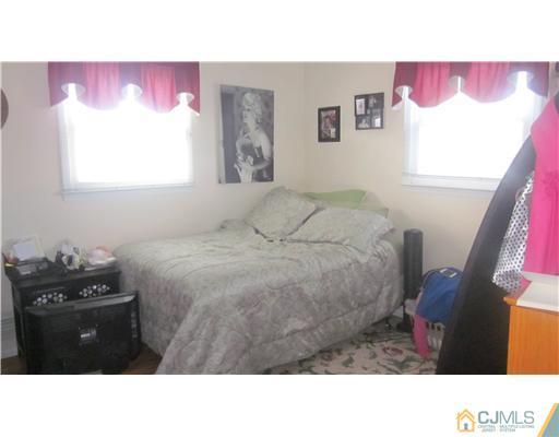 57 South Cliff Road Colonia, NJ 07067 - Photo 9 of 15 a bedroom with a bed and a window