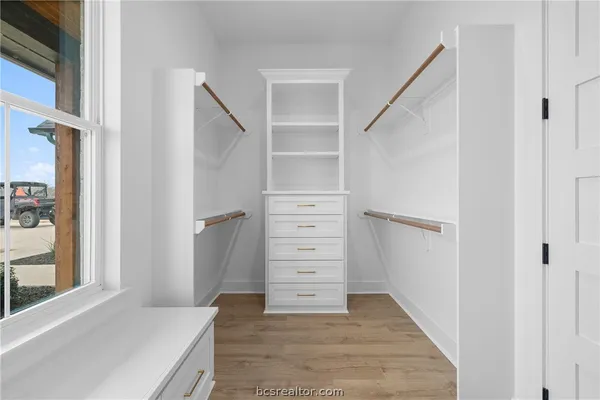 a room with a window and a ceiling fan