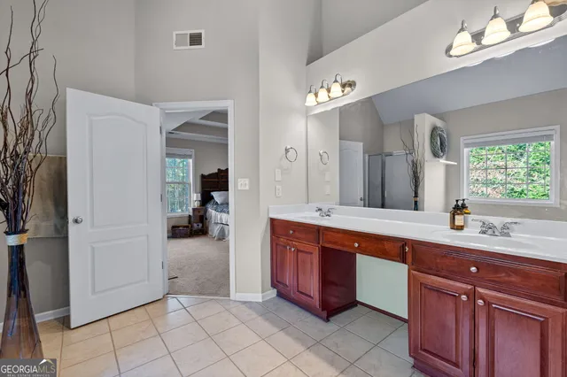 a large bathroom with a sink mirror and a bathtub