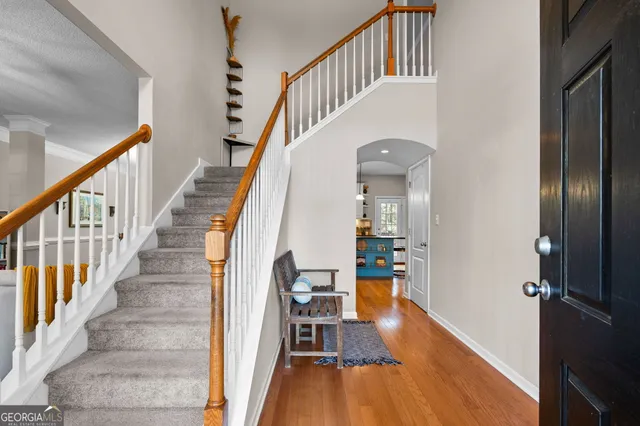 a view of entryway and hall with wooden floor
