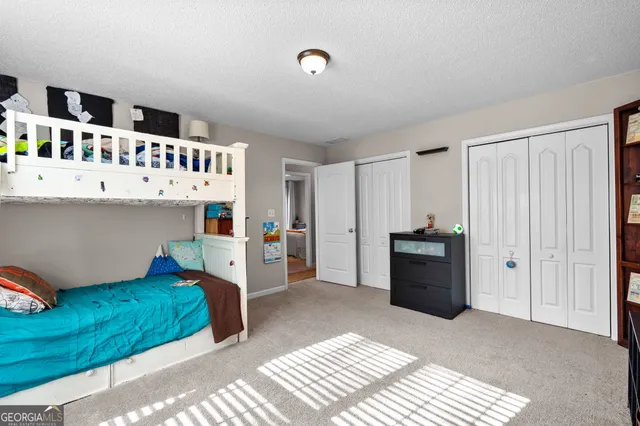 a bedroom with furniture and a window