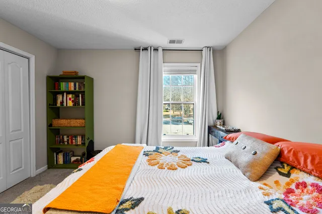 a bedroom with a bed and a book shelf