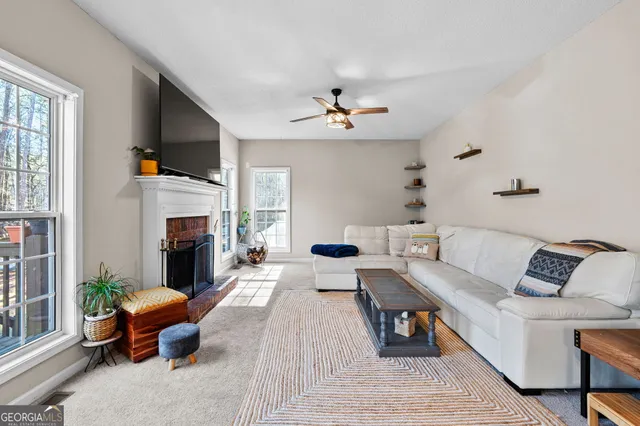 a living room with furniture a fireplace and a flat screen tv