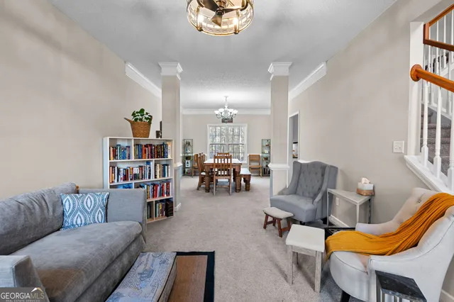 a living room with furniture a rug and a bookshelf