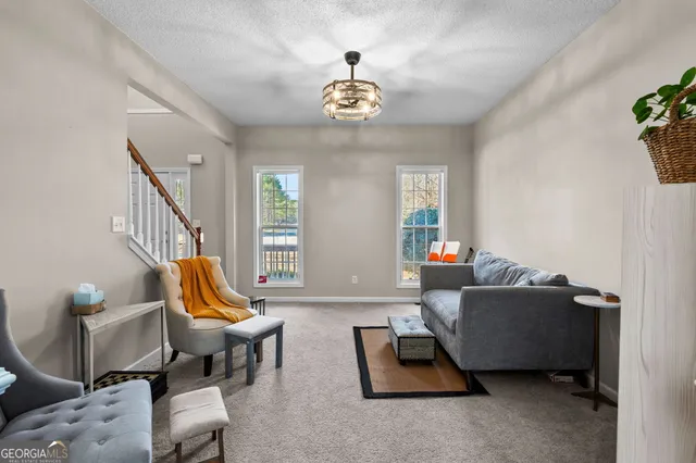 a living room with furniture and a chandelier