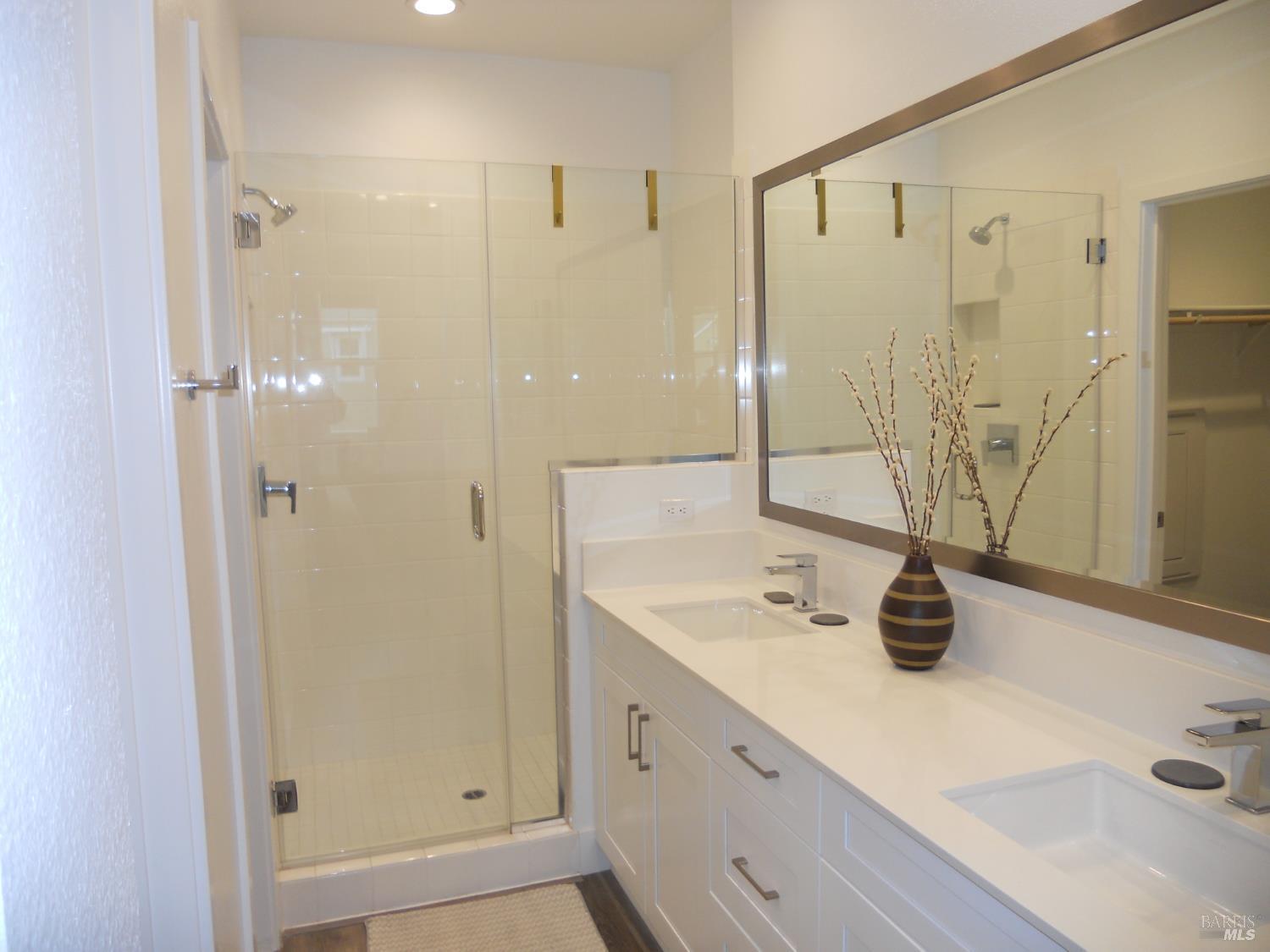 451 Semillon Lane Santa Rosa, CA 95403 - Photo 17 of 23 a bathroom with a double vanity sink a mirror and shower