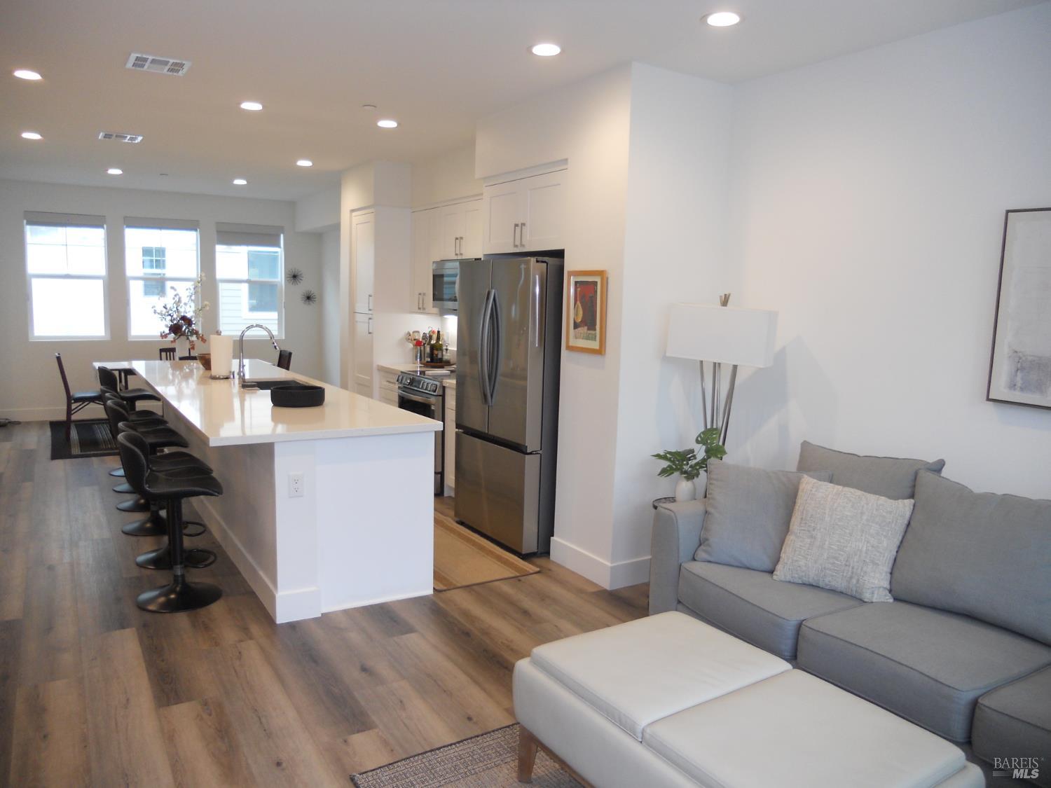 451 Semillon Lane Santa Rosa, CA 95403 - Photo 7 of 23 a living room with furniture a refrigerator and a dining table