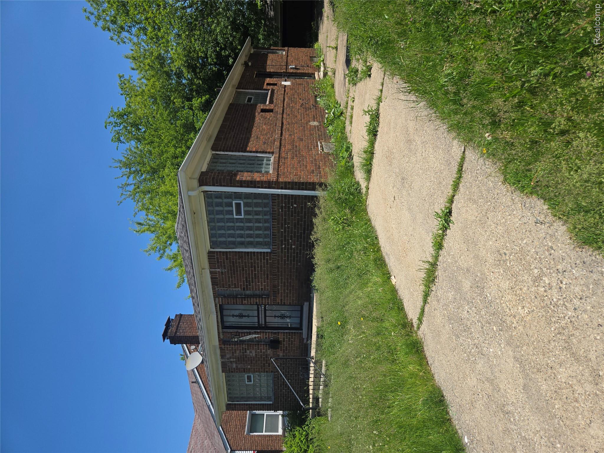 10342 Roxbury Street Detroit, MI 48224 - Photo 2 of 30 Brick exterior with a prominent chimney