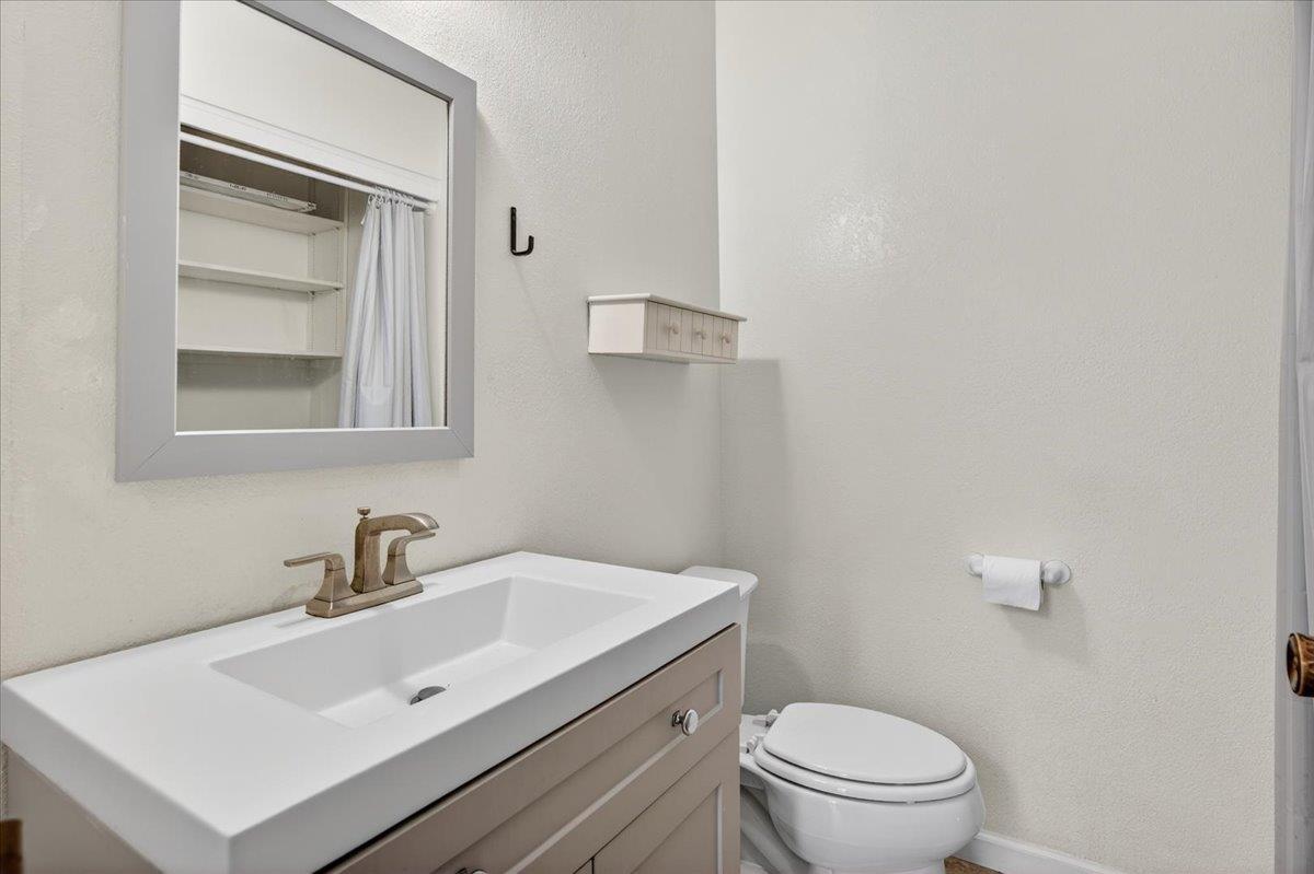 4875 North Backer Avenue, Unit 143 Fresno, CA 93726 - Photo 11 of 27 a bathroom with a sink toilet and mirror