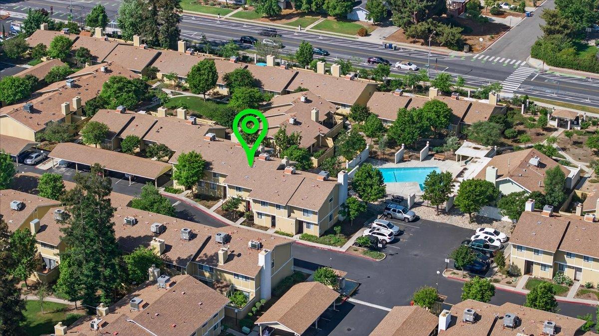 4875 North Backer Avenue, Unit 143 Fresno, CA 93726 - Photo 2 of 27 an aerial view of a house with a yard