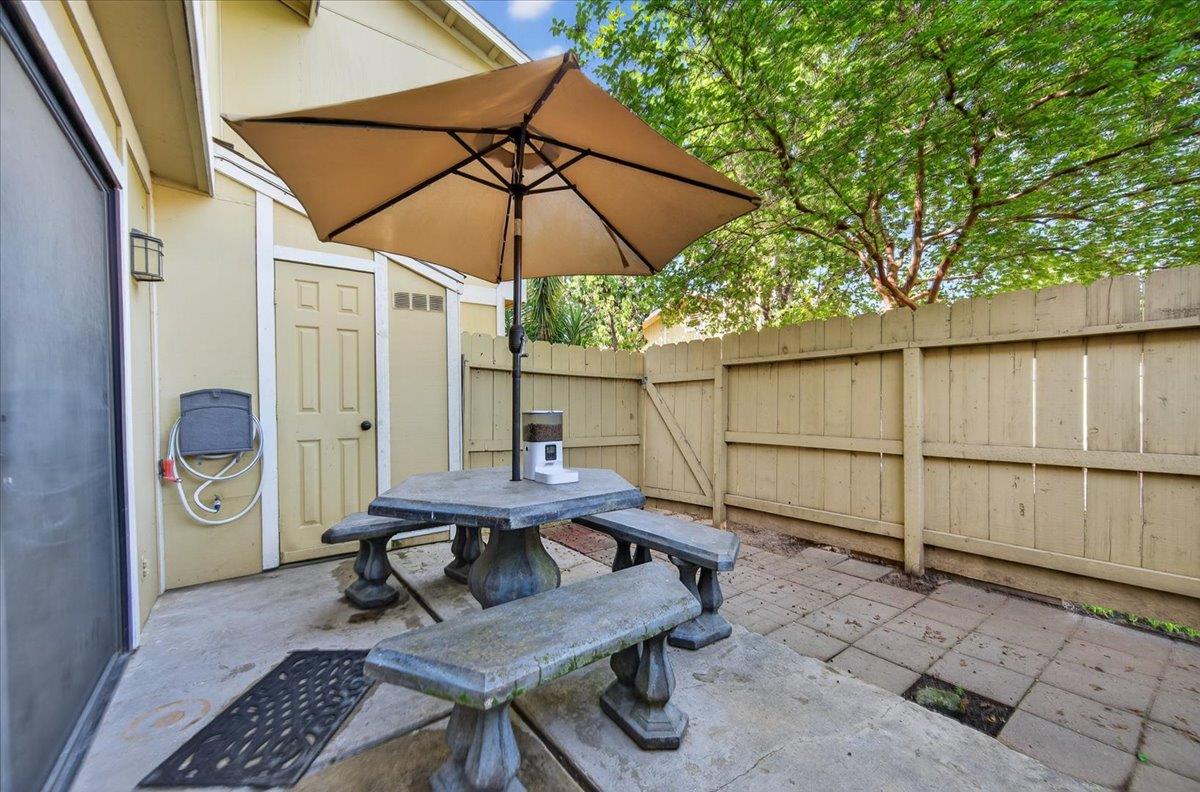 4875 North Backer Avenue, Unit 143 Fresno, CA 93726 - Photo 24 of 27 a backyard of a house with table and chairs
