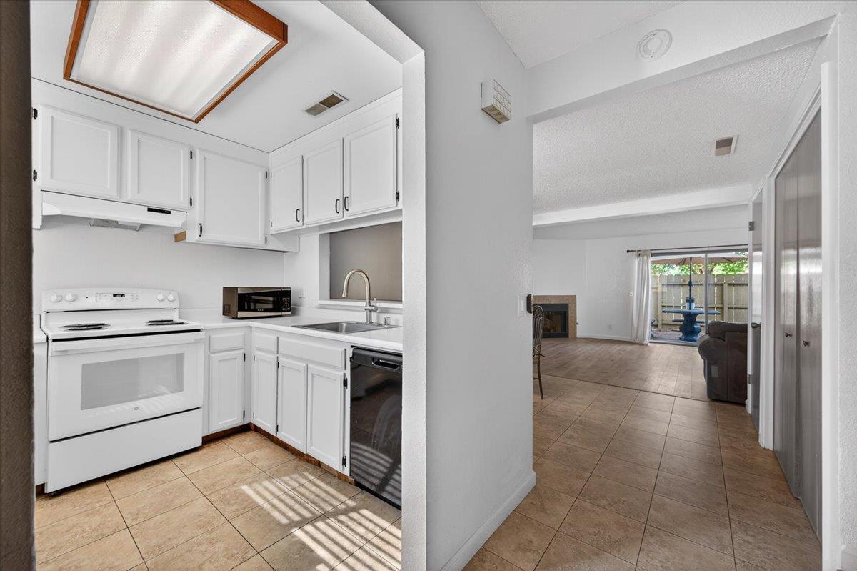 4875 North Backer Avenue, Unit 143 Fresno, CA 93726 - Photo 4 of 27 a kitchen with white cabinets and appliances
