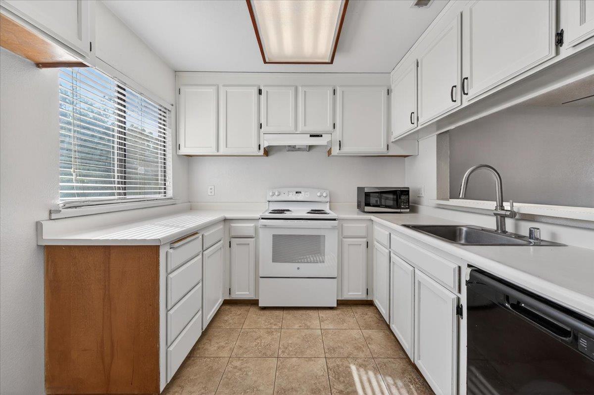 4875 North Backer Avenue, Unit 143 Fresno, CA 93726 - Photo 5 of 27 a kitchen with stainless steel appliances granite countertop a sink and cabinets
