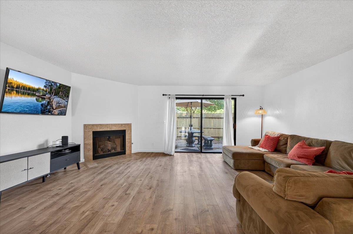 4875 North Backer Avenue, Unit 143 Fresno, CA 93726 - Photo 7 of 27 a living room with furniture and a fireplace