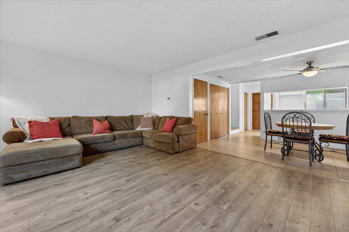 4875 North Backer Avenue, Unit 143 Fresno, CA 93726 - Photo 9 of 27 a living room with furniture and a wooden floor