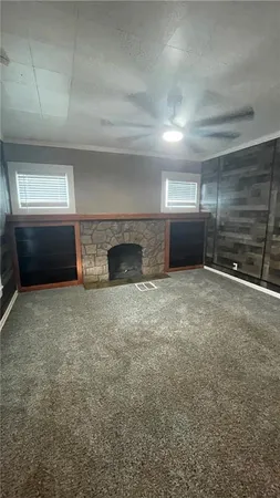 a view of an empty room with a fireplace