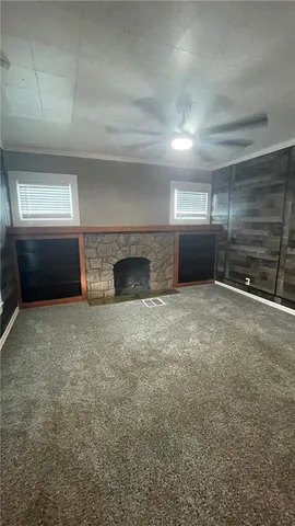 a view of an empty room with a fireplace