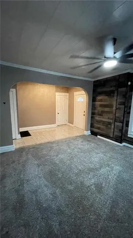 a view of an empty room with closet and garage