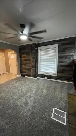 a view of a livingroom with an empty space and a window