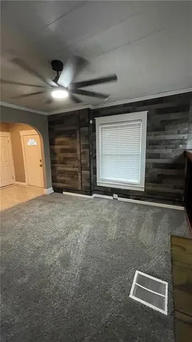 a view of a livingroom with an empty space and a window