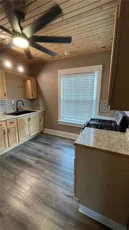 a kitchen with stainless steel appliances granite countertop a stove and a sink