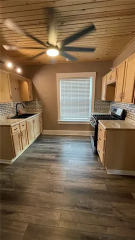 a view of a kitchen counter top space and wooden floor