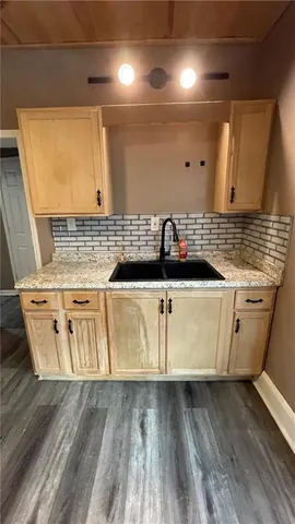 a view of a room with wooden floor