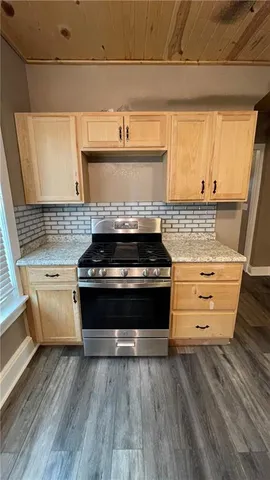 a stove top oven sitting inside of a kitchen