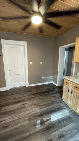 a view of an empty room and wooden floor