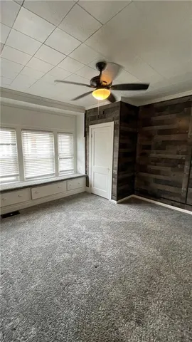 a view of an empty room with a fireplace and a window