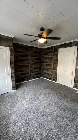 a view of room with stairs and a ceiling fan