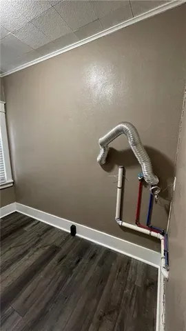 a view of a room with wooden floor