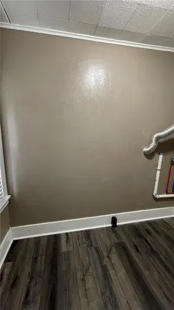 a view of a room with wooden floor