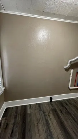 a view of a room with wooden floor