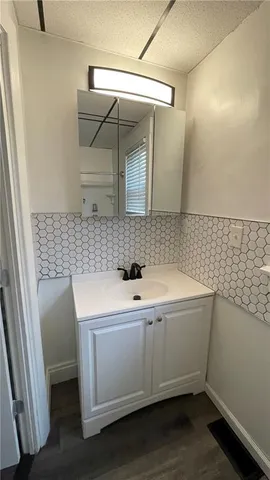 a bathroom with a sink and mirror