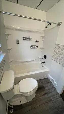 a bathroom with a sink a toilet and bathtub