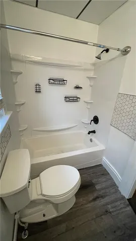 a bathroom with a sink a toilet and bathtub