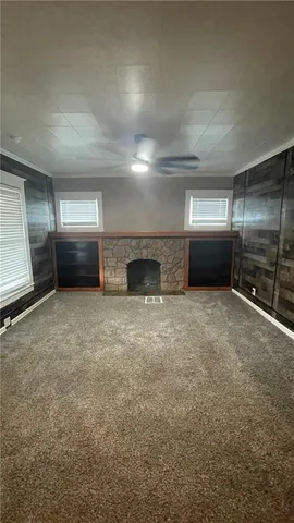 a view of an empty room and a fireplace