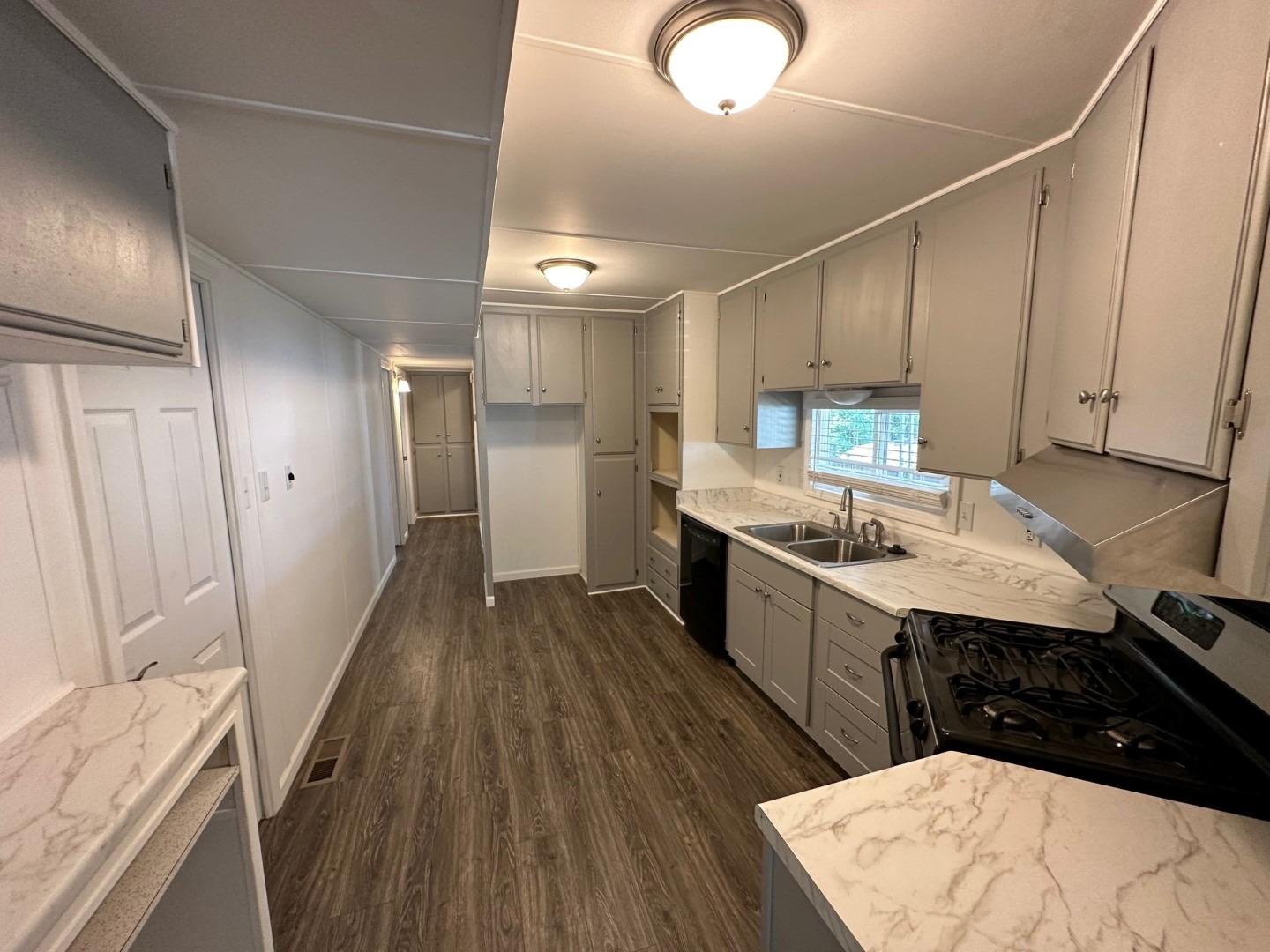 a kitchen with a sink appliances and cabinets