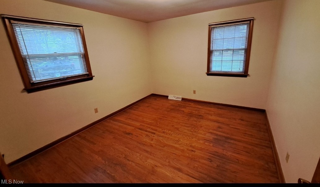 4735 New Road Youngstown, OH 44515 - Photo 19 of 36 Spare room with hardwood / wood-style flooring and a healthy amount of sunlight